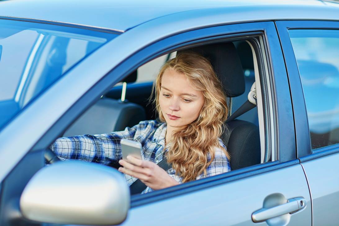A person in a car looking at her phone
AI-generated content may be incorrect.
